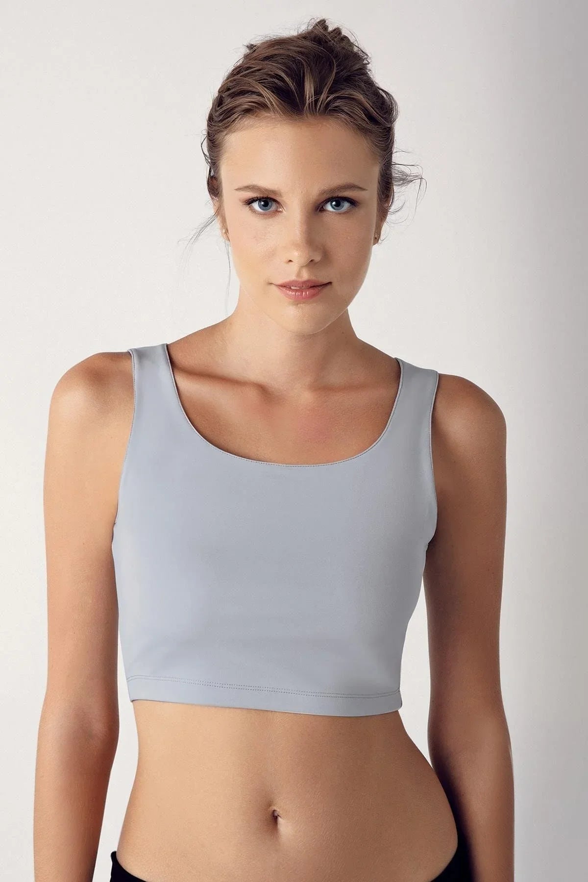Woman wearing a light grey thick-strap crop top bustier from Artış Collection