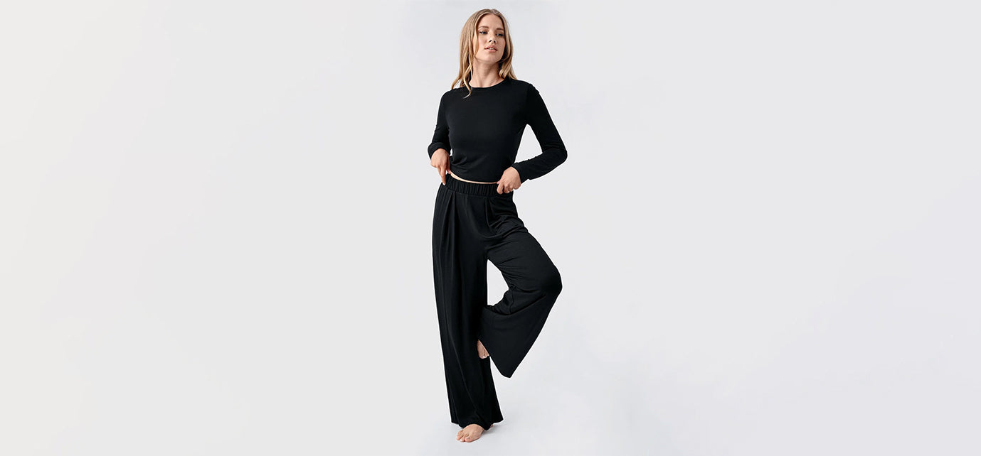 Woman in black loungewear set posing on white background, Artış Collection homewear