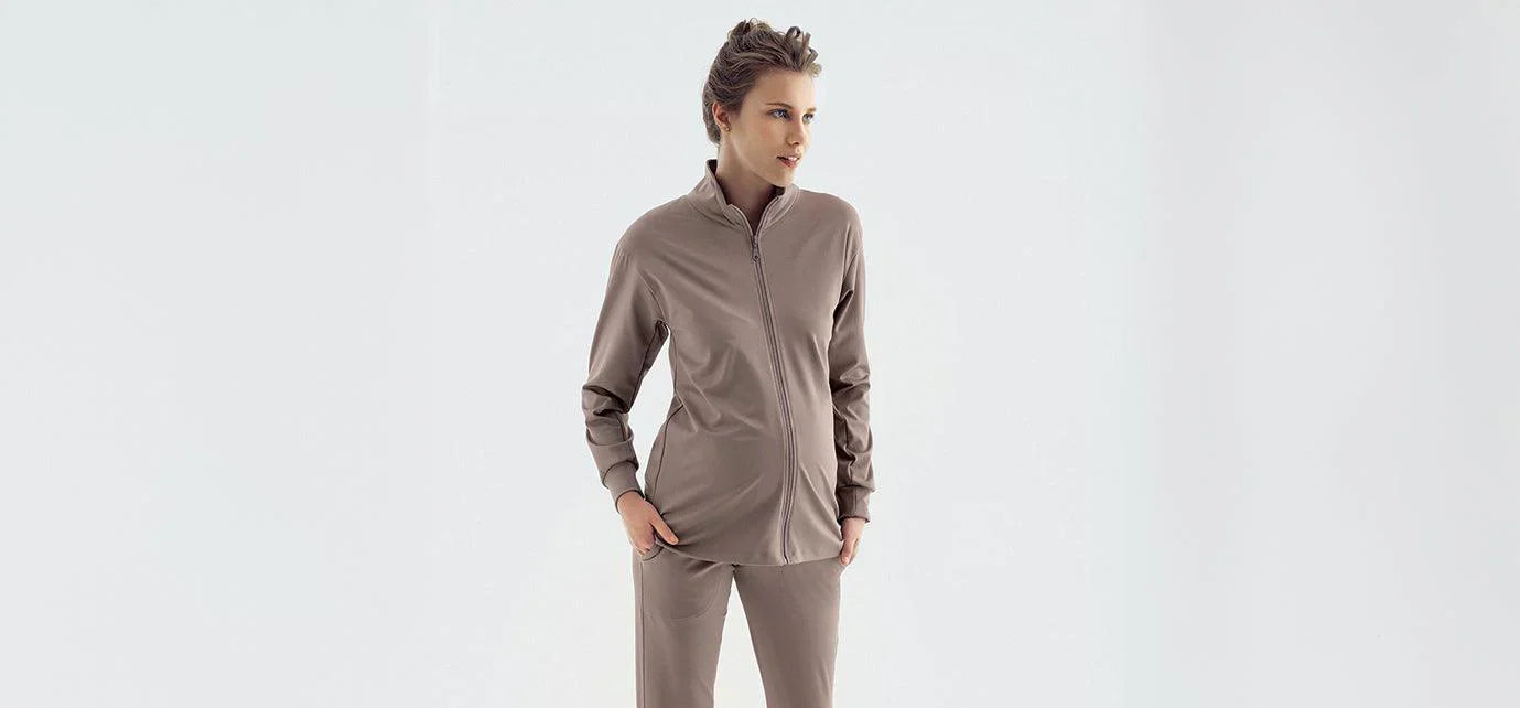 Pregnant woman in beige maternity loungewear set from Artış Collection on light background
